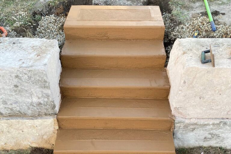 Concrete garden stairs set between sandstone blocks