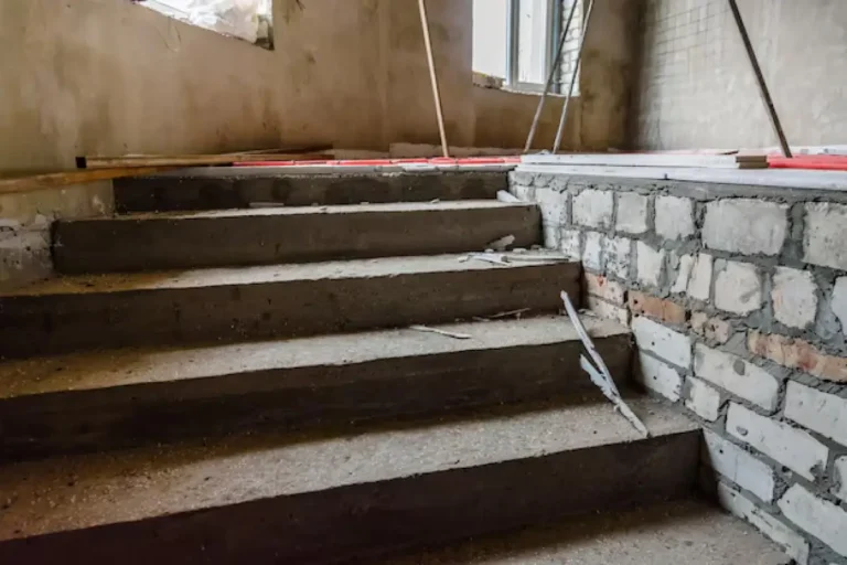 New concrete steps beside a brick wall