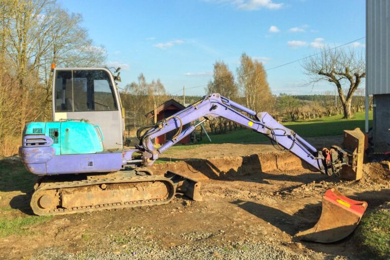 Mini excavator preparing a site for new concrete