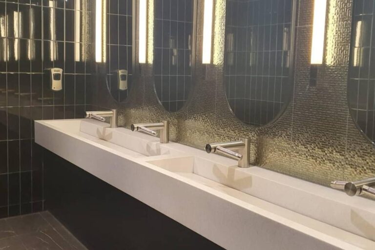Commercial bathroom fit-out with a long solid surface basin at a Bella Vista hotel