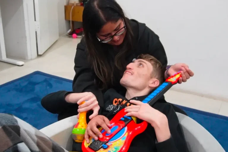 Insite Care support worker playing music with a participant