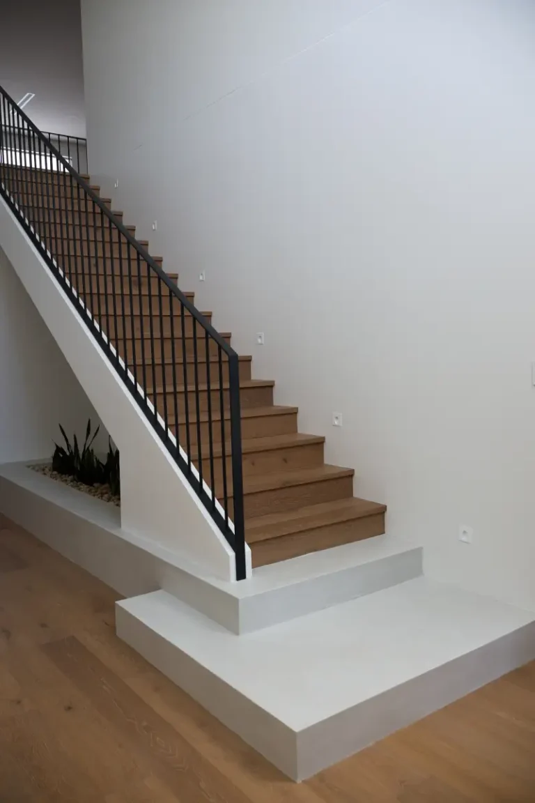 Microcement wall finish beside a timber staircase