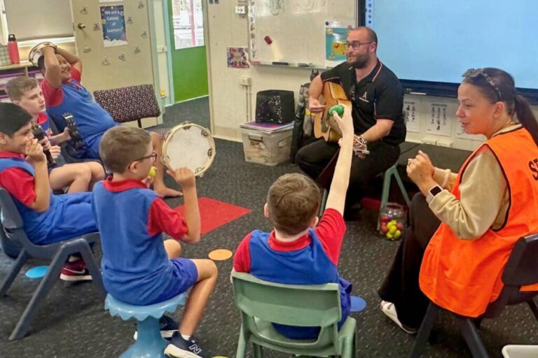 Students playing percussion instruments in a mobile music therapy session