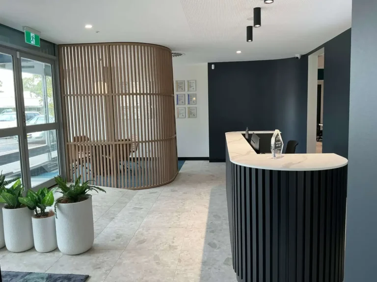 Curved reception counter and timber batten feature in an office fit-out in Mount Druitt