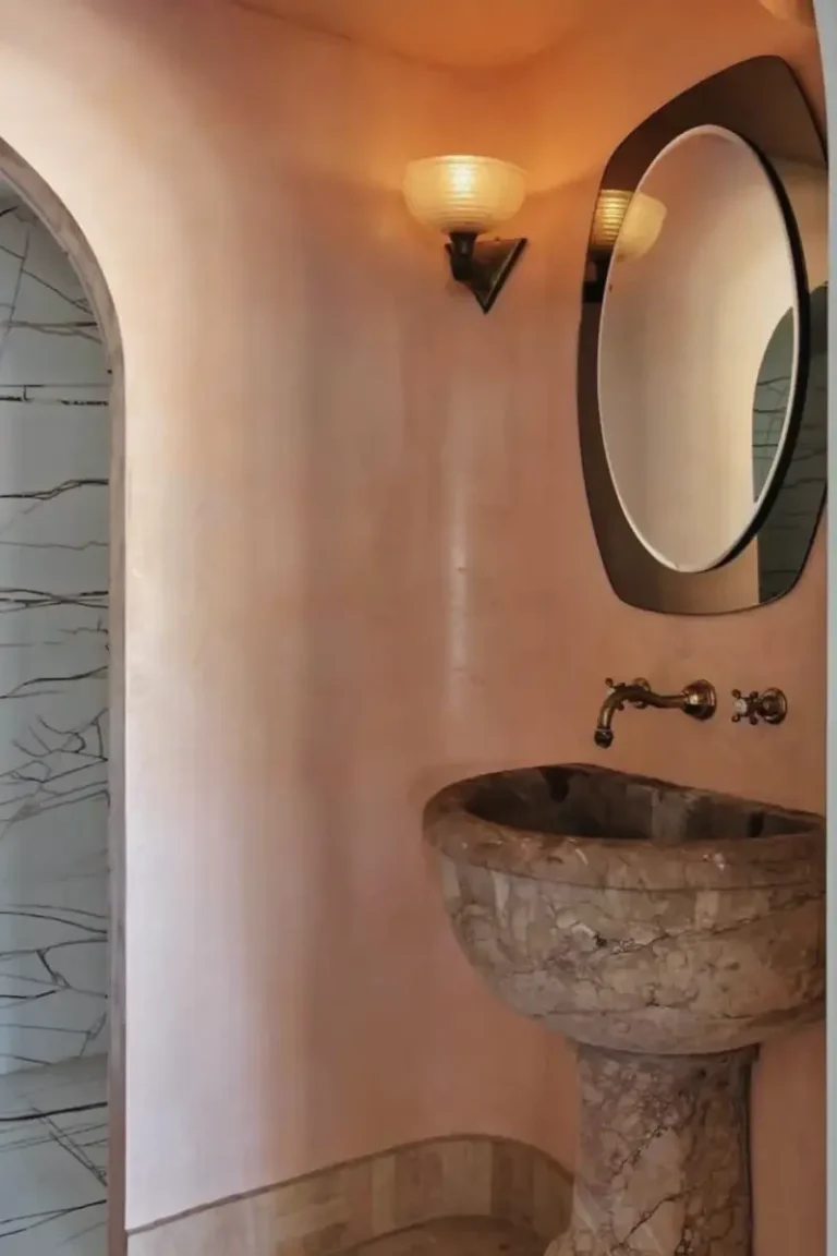 Venetian plaster powder room wall with a stone basin and wall mixer