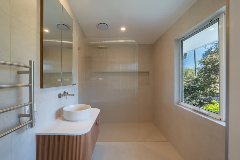 New bathroom with a vessel basin, ribbed tiles and a heated towel rail