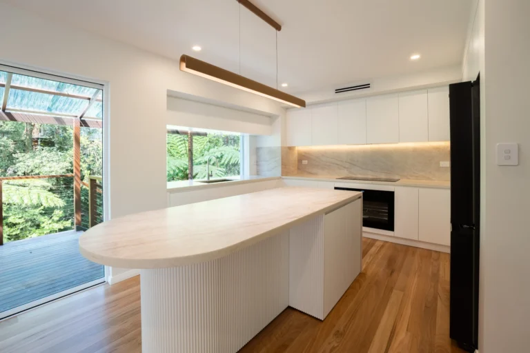 Renovated kitchen with a curved island bench and bush views