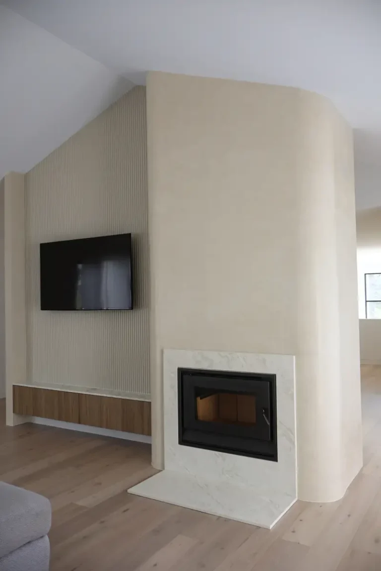 Venetian plaster wall with a mounted television and timber battens